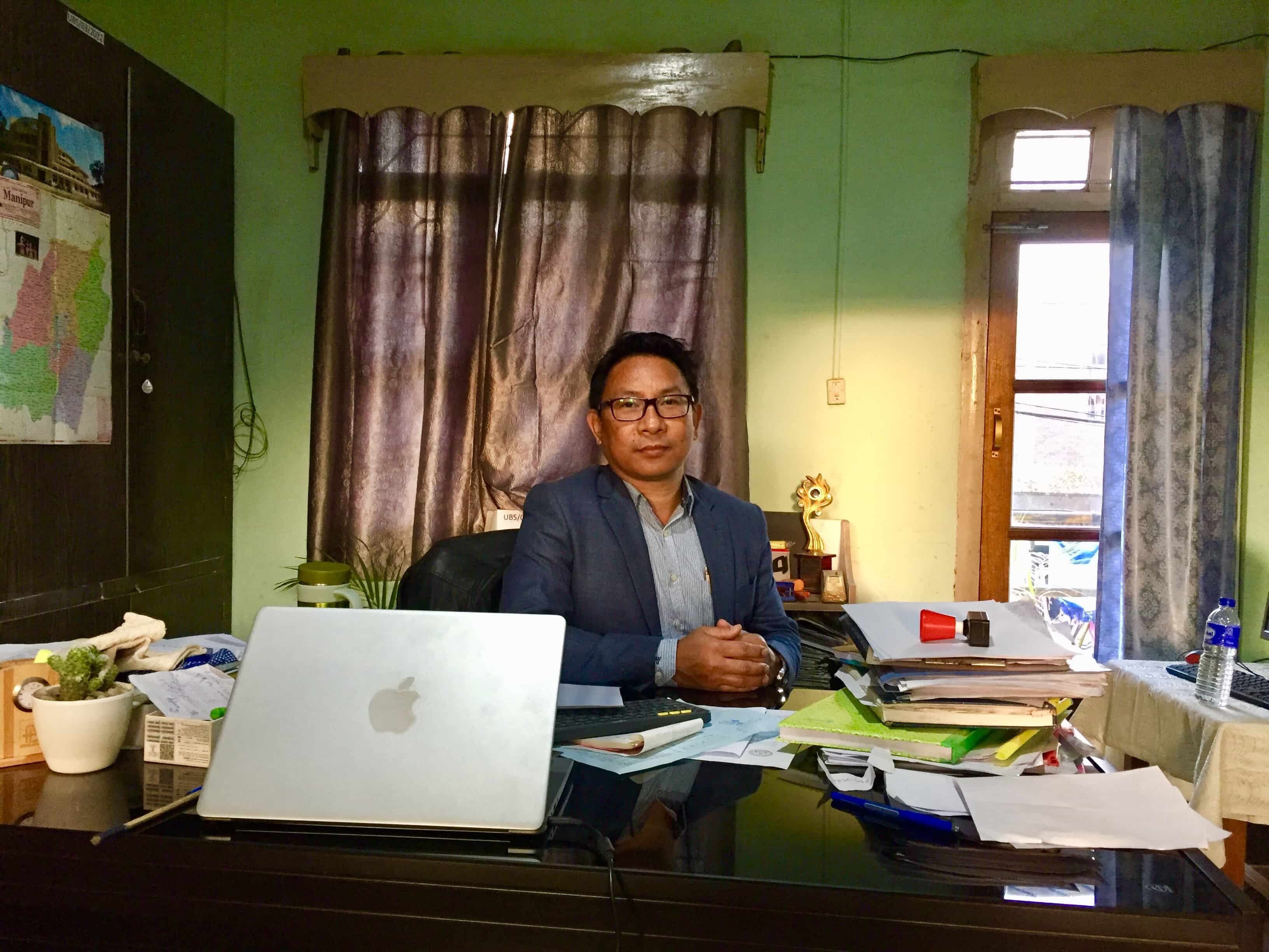 Dr. Lungthuiyang Riamei at his desk in the principal’s office